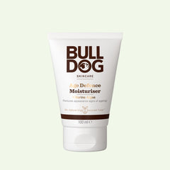 A 100ml white tube of Age Defence Moisturiser for men with natural origin ingredients and Marine Algae, featuring brown text and a white cap, is shown against a light background.